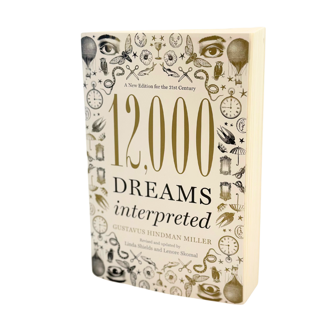 Book titled '12,000 Dreams Interpreted' with decorative cover on a white background