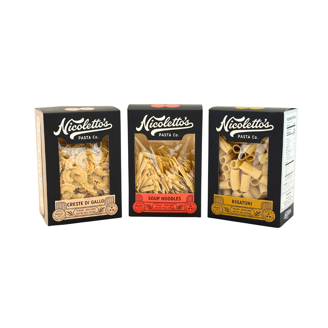 Three packages of Nicoletto's Pasta Co. pasta on a white background