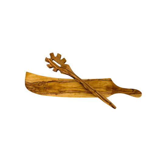 Olive wood serving board with a olive wood pasta spoon on a white background